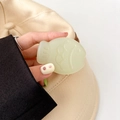 Macro detail of mint green fish-shaped phone grip with matte resin texture and engraving - Matte Light Jelly Jasmine Green