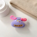 Detail of cute purple plush cartoon dog phone stand with fine embroidery on white background - Purple