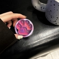 Detailed macro view of a 3D cat paw phone grip with heart embossing and Good Luck text - Blue Light Matte Magnetic Cat Claw / Bright Purple