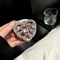 Macro shot of heart-shaped rhinestone phone grip with pink gems and hand-held detail - Large Rhinestone Heart / Pink