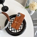 Dettaglio custodia in pelle marrone con cinturino a cuore su piatto a scacchiera - Marrone / iPhone 7/8/SE 2020