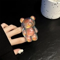 Macro detail of iridescent laser teddy bear phone grip stand with holographic finish - Shiny Grey