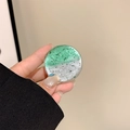 Macro detail of round phone grip with green silver foil flakes in transparent resin - Gradient Green