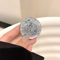 Detail of the silver foil phone grip with artistic black terrazzo stone texture surface - Gray