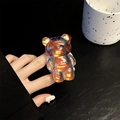 Macro shot of 3D bear phone grip with iridescent laser finish and clear resin texture - Dazzling Brown