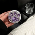 Close-up of a sparkling purple gemstone cat paw phone socket holder being held by a hand - Full Rhinestone Cat Paw / Purple
