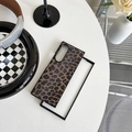 Leopard print folding phone case set on a stylish table with fashionable lifestyle accessories - Leopard Brown / Samsung ZFlip3