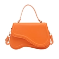 Vibrant orange faux leather handbag with asymmetrical curved flap and gold-tone hardware - Orange