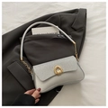 Detail of silver sequin shoulder bag with golden horseshoe buckle on grey blazer - Silver