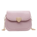 Pink PU leather crossbody bag with heart-shaped gold clasp and chain strap on white background - Pink