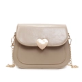 Chic beige crossbody bag featuring a glossy leather finish and golden heart clasp - Khaki