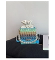 Detailed shot of multi-color woven bucket bag with pearl handle and drawstring closure - Light Blue