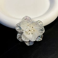 Macro detail of iridescent 3D floral phone grip with white pearl and gold bead stamen - Adhesive Type / White