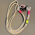 Close-up of colorful braided crossbody phone strap with a cute cartoon cat clip and smile tag - No.6 Cat with Pink Hat - Woven Rope