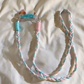 Detail of blue, pink, and white braided phone lanyard with cute cartoon puppy charm - No. 25 Blue Polka Dot Party Dog - Three-strand Rope