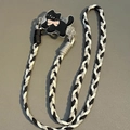 Close-up of hand-woven black and white lanyard with a cute cartoon cat acrylic clip - No.5 Black Cat with Pink Bowtie - 3-Strand Rope