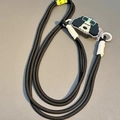 Detail of a thick black braided phone lanyard with a cartoon dog charm and white accents - No.1 Curly Hair Sunglasses Dog - Woven Rope