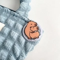 Detailed view of a cute cartoon capybara acrylic phone socket on a textured blue bag - Double Layer Capybara (No. 12)