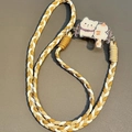 Detail of woven phone strap featuring a cute cat acrylic charm and metal connector - No.4 Yellow Spotted Cat - 3-Strand Rope