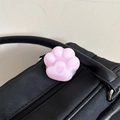 Detailed view of a cute pink cat paw phone grip with heart detail on black leather bag - Frosted Cat Paw Stand-Jelly Purple