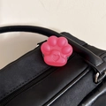 Close-up of a pink cat paw phone grip with heart detail on a black leather bag - Frosted Cat Paw Stand-Jelly Rose Red