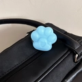 Detail showing a light blue cat paw phone socket with heart relief on a black leather bag - Frosted Cat Paw Stand-Jelly Blue