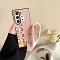 Close-up of pink leather phone case featuring 3D cute puppy charms and a wrist strap - Pink / Samsung ZFlip3