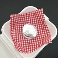 Detail of silver wavy metal phone grip with Abbey engraving on red plaid fabric - Happy Geometric Matte Silver