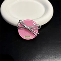 Detailed view of pink glitter resin phone grip with silver ribbon bow on ceramic plate - Standard Style - Pink