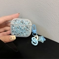 Custodia glitterata blu per AirPods con ciondolo a stella e dettaglio catena - AirPods 1ª/2ª generazione / Ciondolo Stella-Blu