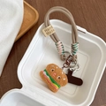 Detail of a cute plush hamburger charm attached to a thick braided phone wrist strap - Burger Style / Khaki Braided Rope