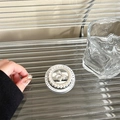 Macro detail of a pearl phone grip with mirror finish and 3D silver bow accent - Pearl Bow Mirror Magnetic Style