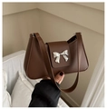 Detailed view of brown retro underarm bag featuring a metallic silver butterfly clasp - Brown