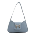 Light blue faux leather baguette bag with a stylish silver metal bow decoration - Blue