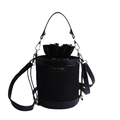 Chic black bucket bag with textured fabric, drawstring liner and golden hardware accents - Black