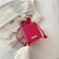Chic rose red drawstring bucket bag with gold chain strap on white knit fabric - Rose Red