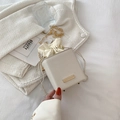 Chic beige textured bucket bag with drawstring closure and golden chain strap - White
