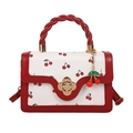 Mini white handbag with red cherry prints, braided handles and flower clasp accessory - Red