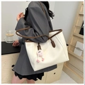 Elegant white faux leather tote bag with brown straps and cute pink monster charm accessory - White With Pendant