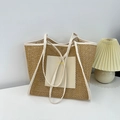 Brown woven tote bag with creamy white leather trim and straps in a minimalist home setting - White