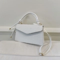 Detail of a white textured crossbody bag with gold hardware and knotted handle - White