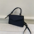 Detailed view of a black vintage small square crossbody bag with textured fabric - Black