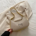 Fashionable beige woven crescent bag with silver bow accent and leather shoulder strap - Gold