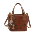Brown leather bucket bag with embossed patterns and a cute monster plush charm - With Charm / Brown