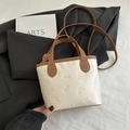 Cream bucket bag with whimsical embossed patterns and contrasting brown top handle - No Pendant / White