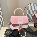 Chic pink textured leather handbag for women featuring a golden buckle and round handle - Pink