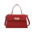 Red tweed handbag with gold metal lock and shoulder strap on white background - Red