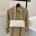 Minimalist white rectangular shoulder bag with ribbon bows on a khaki trench coat background - White No Silk Scarf