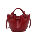Glossy red bucket bag with knotted handles and drawstring design for summer fashion - Red