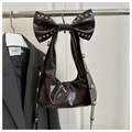 Detail of dark brown glossy patent leather bag with silver rivets and bow decoration - Brown